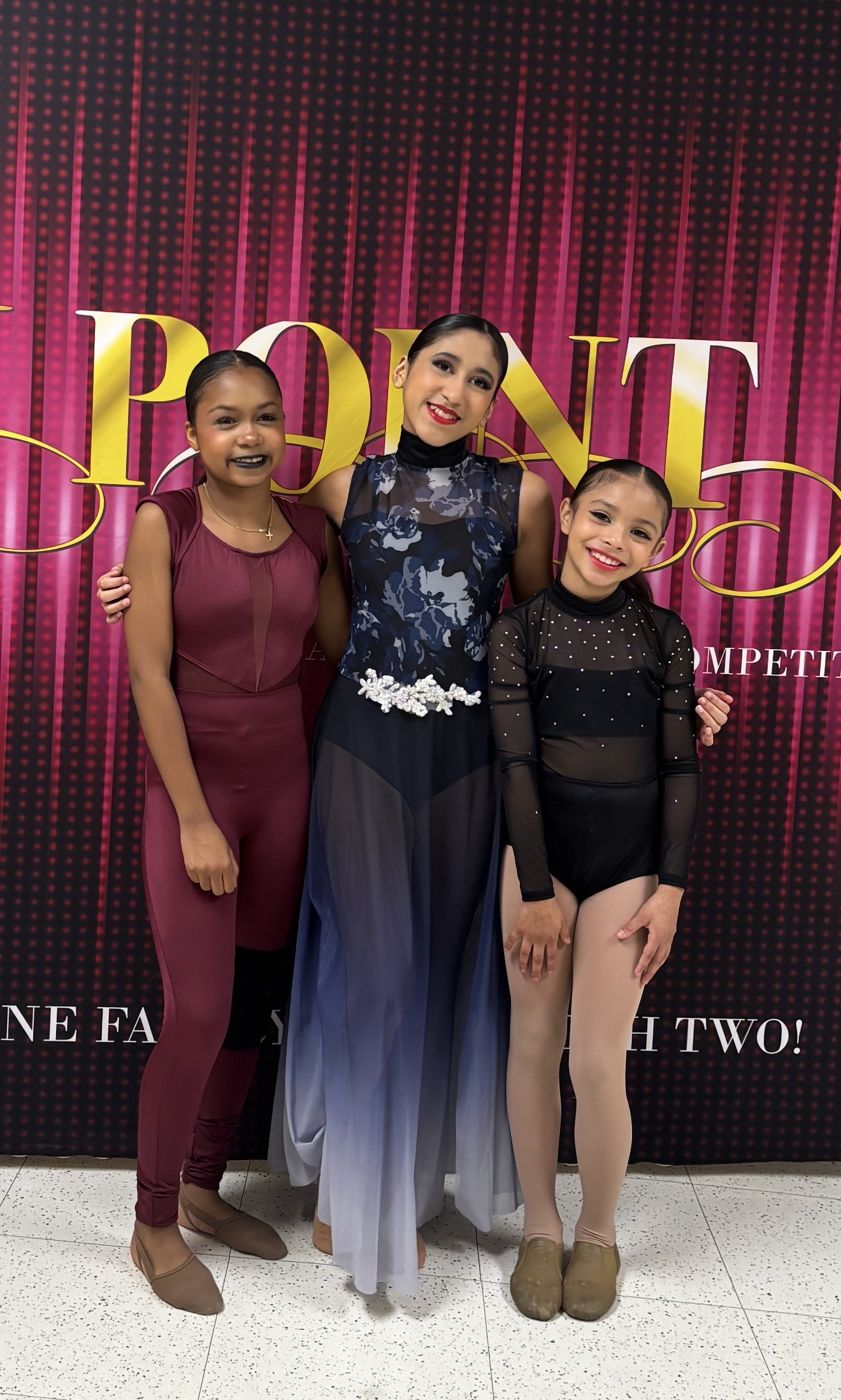 Three company dancers in lyrical and contemporary costumes
