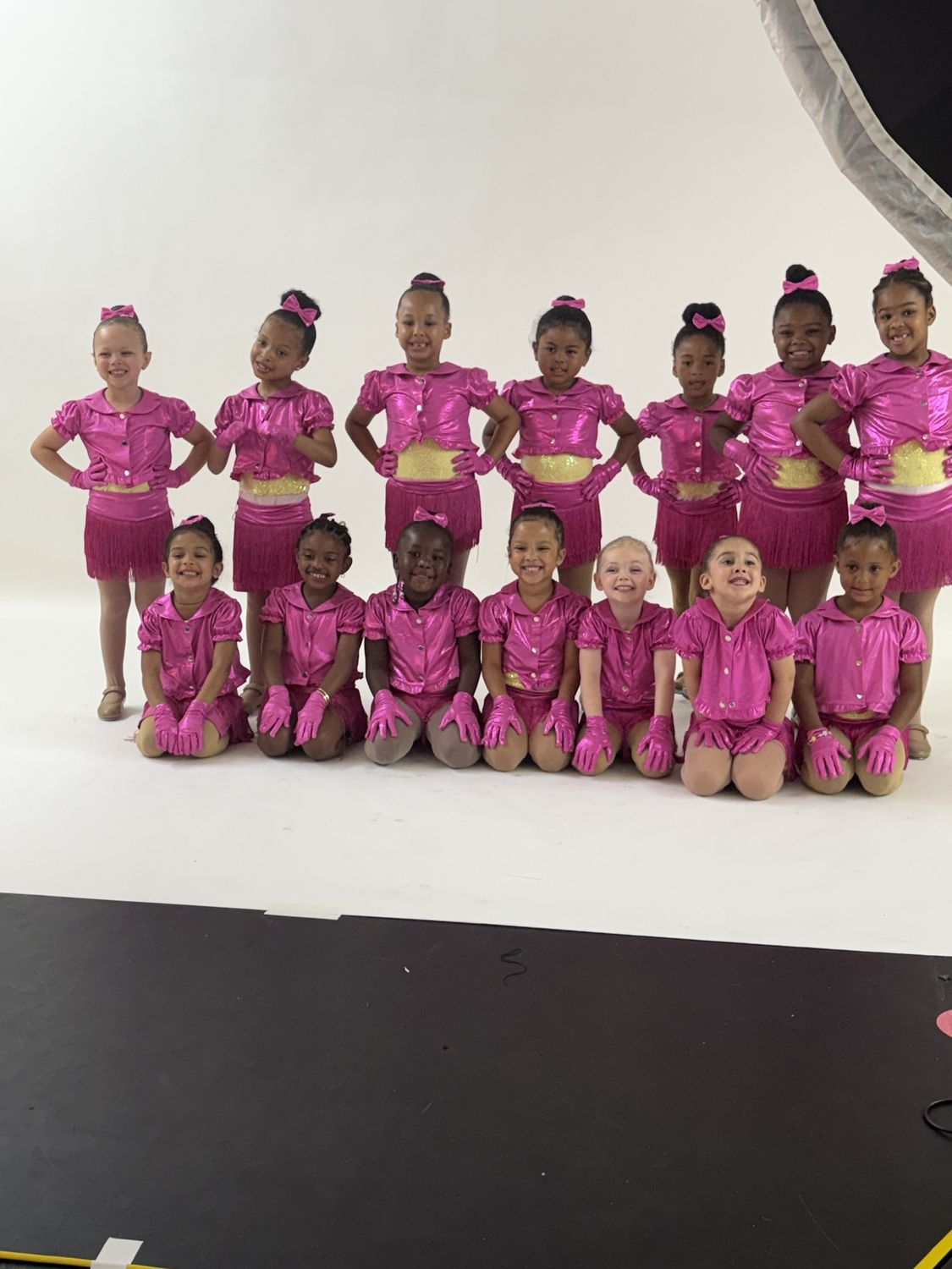 Young tap dancers in pink fringe costumes and gloves at their glamour photo shoot