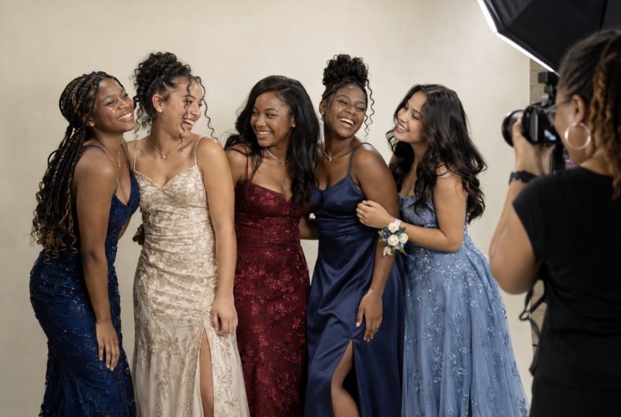 Senior dancers laughing together in formal gowns at their yearly photo shoot