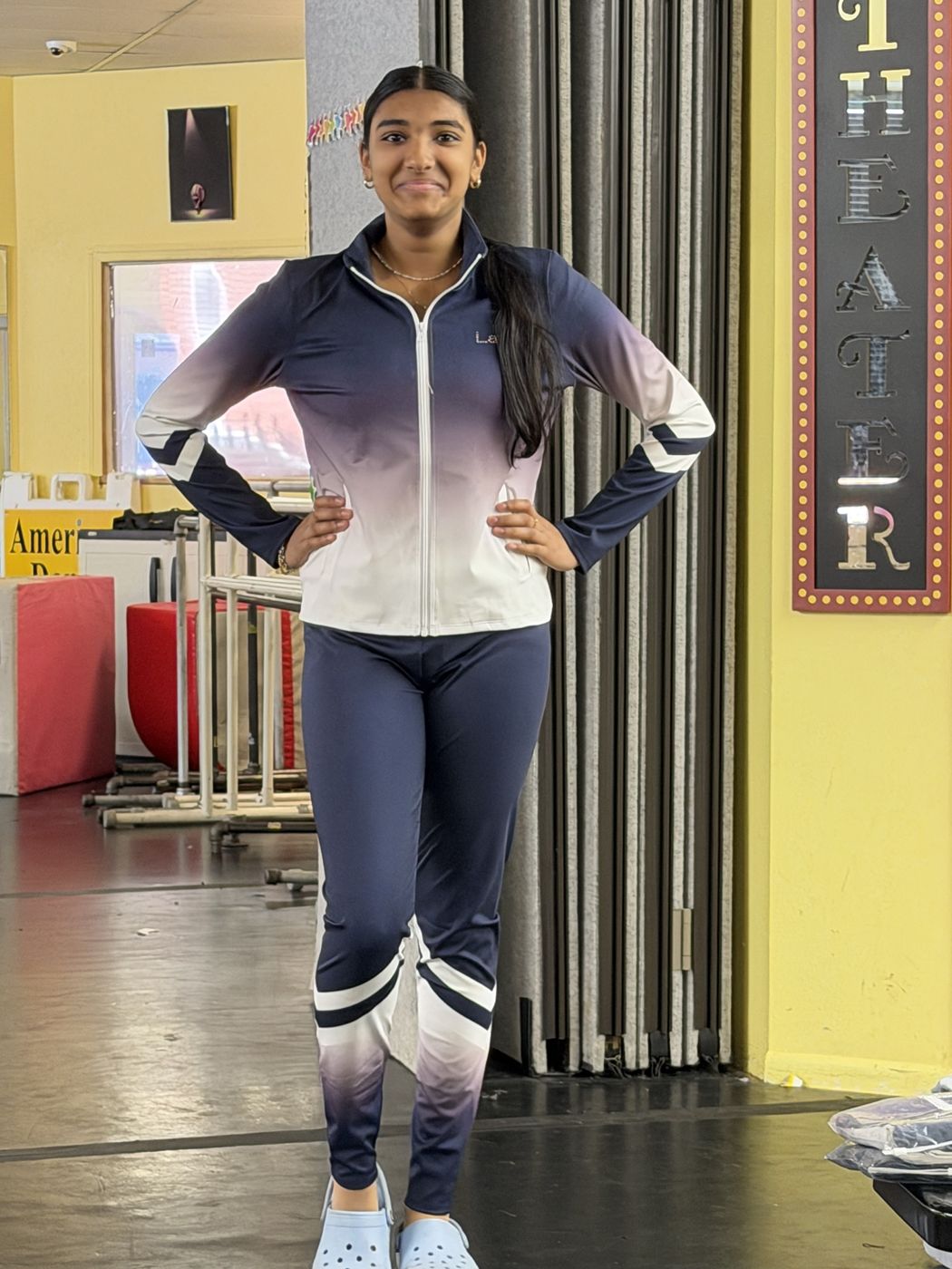 A company dancer in the navy and white team warm-ups